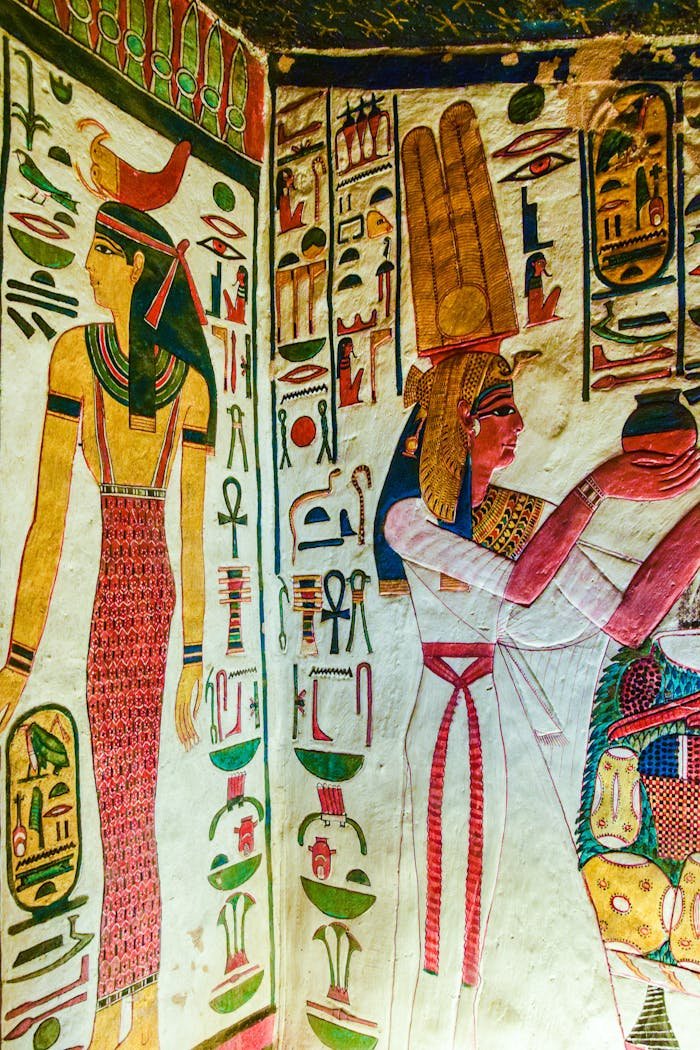 Vibrant ancient Egyptian mural featuring gods and hieroglyphics on a wall.