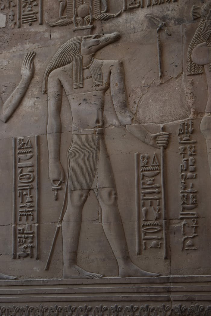 Detailed depiction of ancient Egyptian hieroglyphics carved on a stone wall.