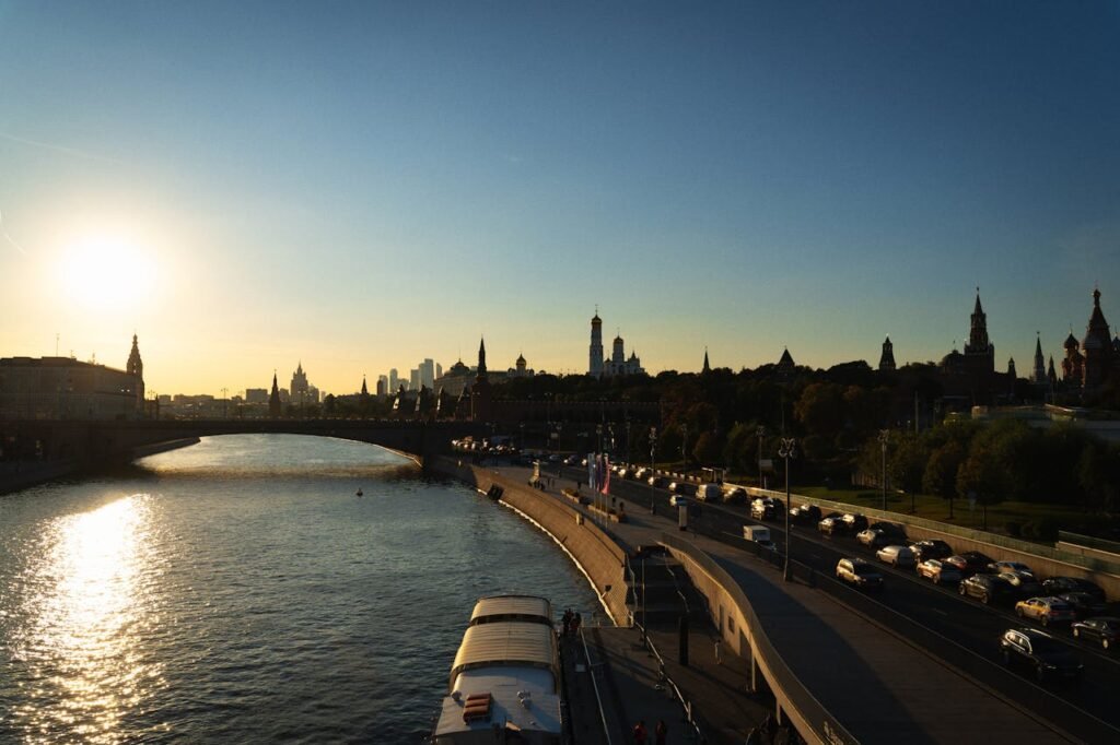 Beautiful sunset view of the Moscow River featuring iconic city skyline and bridge.